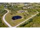 A beautiful property with a house, large yard, detached garage, pond, and a winding road at 25605 69Th E Ave, Myakka City, FL 34251