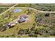 Large property with home, detached garage, pool, lush landscaping, and a peaceful setting at 25605 69Th E Ave, Myakka City, FL 34251