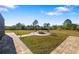 Beautiful backyard featuring a fire pit, brick pavers, well-maintained lawn, and privacy landscaping at 25605 69Th E Ave, Myakka City, FL 34251