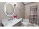 Bathroom featuring a marble vanity, oval mirror, and shower with a curtain at 25605 69Th E Ave, Myakka City, FL 34251