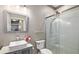 Bathroom featuring a modern sink and a frameless glass shower with decorative pebble flooring at 25605 69Th E Ave, Myakka City, FL 34251