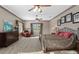 Large bedroom with a wrought iron bed frame, wood dresser, and large windows at 25605 69Th E Ave, Myakka City, FL 34251