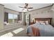 Bright bedroom features a window seat, ceiling fan, and plush carpeting at 25605 69Th E Ave, Myakka City, FL 34251