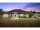 Charming single-story home with manicured lawn, stone accents, covered entry and paver walkway at 25605 69Th E Ave, Myakka City, FL 34251