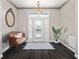 Elegant foyer featuring hardwood floors, decorative light fixture, and leaded glass front door at 25605 69Th E Ave, Myakka City, FL 34251