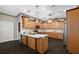 Spacious kitchen featuring wood floors, an island, stainless steel appliances, and wood cabinets at 25605 69Th E Ave, Myakka City, FL 34251