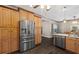 Kitchen featuring wood floors, stainless steel refrigerator, cabinets, and a dining room at 25605 69Th E Ave, Myakka City, FL 34251
