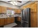 Well-lit kitchen features stainless appliances and oak cabinets at 25605 69Th E Ave, Myakka City, FL 34251