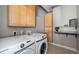 Neat laundry room featuring modern appliances and ample storage space at 25605 69Th E Ave, Myakka City, FL 34251