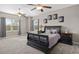 Main bedroom featuring neutral paint, large window, and ceiling fans at 25605 69Th E Ave, Myakka City, FL 34251