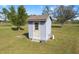 Outbuilding exterior with a well-maintained lawn and light-grey siding at 25605 69Th E Ave, Myakka City, FL 34251