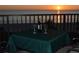 Balcony table with wine and a serene sunset view overlooking the beach at 2675 Gulf Of Mexico Dr # 301, Longboat Key, FL 34228