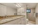 Well-lit bathroom featuring a double sink vanity, overhead lighting, and a glass-enclosed shower at 2675 Gulf Of Mexico Dr # 301, Longboat Key, FL 34228
