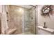 Tiled bathroom with a glass shower and a decorative wreath adding a touch of coastal charm at 2675 Gulf Of Mexico Dr # 301, Longboat Key, FL 34228