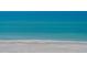 Peaceful view of the water meeting the white sand at 2675 Gulf Of Mexico Dr # 301, Longboat Key, FL 34228