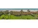 Expansive view of the beach with palm trees and lush greenery from an elevated vantage point at 2675 Gulf Of Mexico Dr # 301, Longboat Key, FL 34228