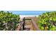 Direct private beach access through wooded path and small bridge at 2675 Gulf Of Mexico Dr # 301, Longboat Key, FL 34228