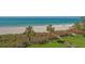 Scenic view of a sandy beach with palm trees and clear turquoise water at 2675 Gulf Of Mexico Dr # 301, Longboat Key, FL 34228
