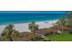 Scenic view of a sandy beach with palm trees and clear turquoise water at 2675 Gulf Of Mexico Dr # 301, Longboat Key, FL 34228