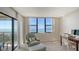 Bright bedroom with large windows showcasing stunning ocean views and balcony access at 2675 Gulf Of Mexico Dr # 301, Longboat Key, FL 34228