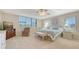 Spacious bedroom with a sitting area by windows, a ceiling fan, and soft, inviting decor at 2675 Gulf Of Mexico Dr # 301, Longboat Key, FL 34228