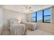 Twin beds by a large window offering scenic views in this peaceful and bright bedroom at 2675 Gulf Of Mexico Dr # 301, Longboat Key, FL 34228