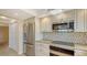Modern kitchen featuring stainless steel appliances, granite counters, and updated cabinetry at 2675 Gulf Of Mexico Dr # 301, Longboat Key, FL 34228