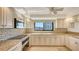 Bright kitchen features granite countertops, modern appliances, and a beautiful mosaic tile backsplash at 2675 Gulf Of Mexico Dr # 301, Longboat Key, FL 34228