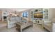 Open-concept living room featuring neutral decor, built-in shelving, and ocean views at 2675 Gulf Of Mexico Dr # 301, Longboat Key, FL 34228