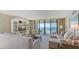 Comfortable living room with large windows showcasing beautiful ocean views and inviting seating at 2675 Gulf Of Mexico Dr # 301, Longboat Key, FL 34228