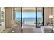 Cozy living room with comfortable seating that opens up to a beachfront balcony with ocean views at 2675 Gulf Of Mexico Dr # 301, Longboat Key, FL 34228