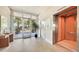 Spacious condo lobby with tile flooring, elevator access, and a glimpse of the beautifully landscaped exterior at 2675 Gulf Of Mexico Dr # 301, Longboat Key, FL 34228