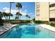 Great community pool with views of the gulf, palm trees, and plenty of lounge chairs at 2675 Gulf Of Mexico Dr # 301, Longboat Key, FL 34228