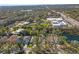 Scenic aerial view of the neighborhood, featuring lush greenery, residential homes, and community ponds at 28 Tall Trees Ct, Sarasota, FL 34232