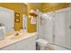 Bathroom featuring a single vanity, shower with glass door, and warm yellow walls at 28 Tall Trees Ct, Sarasota, FL 34232