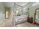This charming bedroom features a unique canopy bed and soft, neutral tones at 28 Tall Trees Ct, Sarasota, FL 34232