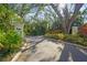 Charming community entrance with lush landscaping and signage, providing a welcoming atmosphere at 28 Tall Trees Ct, Sarasota, FL 34232