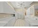 Bright kitchen with tiled floors and white cabinets at 28 Tall Trees Ct, Sarasota, FL 34232