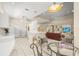 View of the kitchen with bar seating opening up to the living area at 28 Tall Trees Ct, Sarasota, FL 34232