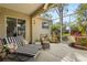 Inviting screened-in lanai with seating area, perfect for outdoor relaxation and enjoying lush surroundings at 28 Tall Trees Ct, Sarasota, FL 34232
