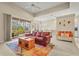 Comfortable living room with a leather sofa, colorful rug, and sliding doors to a screened lanai at 28 Tall Trees Ct, Sarasota, FL 34232