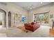 Bright living room featuring a built-in shelving unit and sliding glass doors to the outdoor patio at 28 Tall Trees Ct, Sarasota, FL 34232