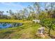 Picturesque view of a tranquil pond with lush landscaping, offering a serene and peaceful environment at 28 Tall Trees Ct, Sarasota, FL 34232