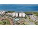 An aerial view of condo buildings, a swimming pool and community amenities near the ocean at 2825 Terra Ceia Bay Blvd # 1505, Palmetto, FL 34221
