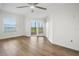 A spacious bedroom with hardwood floors, a ceiling fan, and sliding glass doors to a private balcony at 2825 Terra Ceia Bay Blvd # 1505, Palmetto, FL 34221