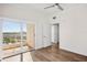 Bedroom with sliding glass doors to the balcony, hardwood floors, and bright lighting at 2825 Terra Ceia Bay Blvd # 1505, Palmetto, FL 34221