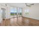 Bright living room with hardwood floors, a ceiling fan and an adjoining balcony with water views at 2825 Terra Ceia Bay Blvd # 1505, Palmetto, FL 34221