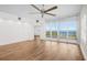 Bright living room with hardwood floors, a ceiling fan and an adjoining balcony with water views at 2825 Terra Ceia Bay Blvd # 1505, Palmetto, FL 34221