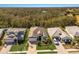 Aerial view of a landscaped home with a brick driveway, well-maintained lawn, and mature trees at 3605 Wild Blossom Pl, Parrish, FL 34219