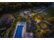 Aerial view of community pool and tennis courts surrounded by lush landscaping and mature trees at 3605 Wild Blossom Pl, Parrish, FL 34219